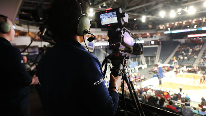 Cameraperson filming a basketball game.