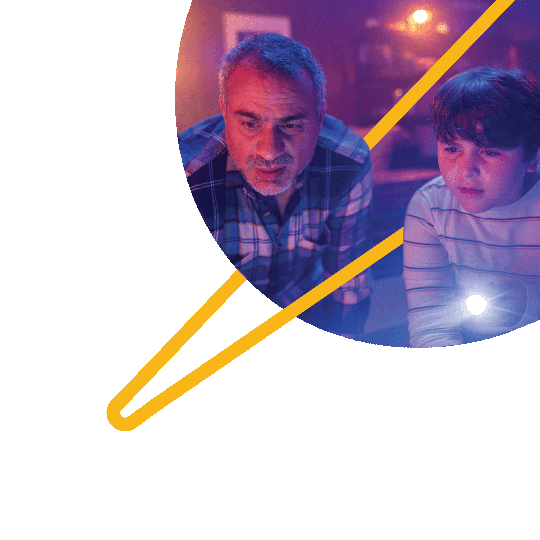 A father and son staring mysteriously at their eero device, trying to figure out how it makes their WiFi work.