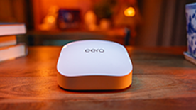 An eero device sitting on top of a wooden coffee table.