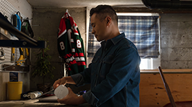 A man self-installing an eero in his garage so he can stream the hockey game.